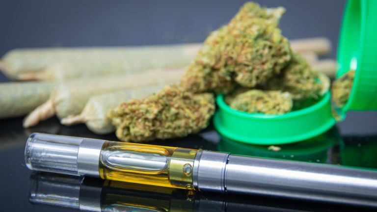 Medical cannabis electronic vape pen THC oil extract and rolled marijuana joints